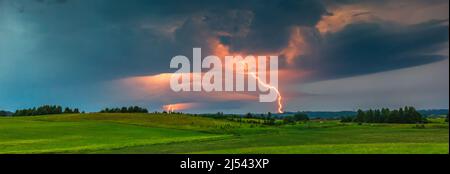 Thunder storm clouds with lightning strikes across the fields, summer, Lithuania Stock Photo