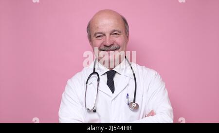 Middle aged hispanic doctor in lab coat and stethoscope smiling looking at camera. Studio shot Stock Photo