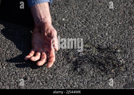 Offenbach, Germany. 20th Apr, 2022. Emergency forces detached the stuck hand of an activist from the 'Last Generation' from the roadway, where he had stuck himself in protest. Activists of the 'Last Generation' blocked the highway exit in Offenbach-Kaiserlei. Credit: Hannes P. Albert/dpa/Alamy Live News Stock Photo