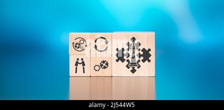 Wooden blocks with symbol of strategic alliance concept on blue background Stock Photo
