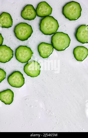 Flat lay cucumber slices with gel on white background, natural medicinal plant for organic cosmetics, alternative medicine, health and beauty spa conc Stock Photo