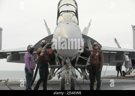 Sailors assigned to USS Gerald R. Ford (CVN 78) and Carrier Air Wing (CVW) 8 refuel an F/A-18F Super Hornet, attached to the 'Blacklions' of Strike Fighter Squadron (VFA) 213, on the flight deck, April 16, 2022.  Ford is underway in the Atlantic Ocean conducting carrier qualifications and strike group integration as part of the ship’s tailored basic phase prior to operational deployment.  (U.S. Navy photo by Mass Communication Specialist 2nd Class Nolan Pennington) Stock Photo