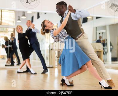 Two professional dancers practicing lindy hop in dance class Stock Photo