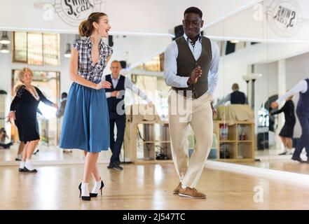 Two professional dancers practicing lindy hop in dance class Stock Photo