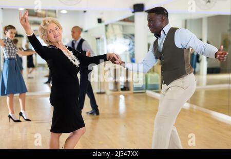 Two professional dancers practicing lindy hop in dance class Stock Photo