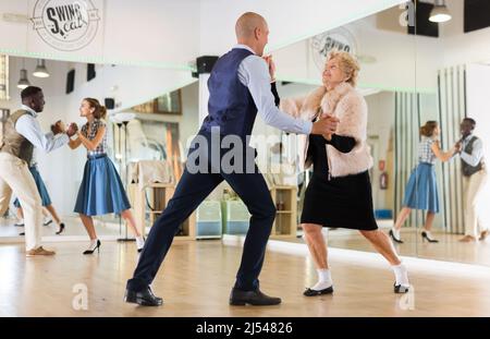 Two professional dancers practicing lindy hop in dance class Stock Photo