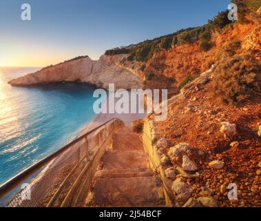 Beautiful stairs on sandy beach at sunset. Porto Katsiki Stock Photo