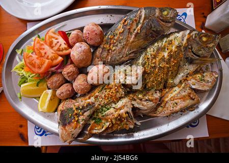 Typical Canarian fish plate with potatoes, different grilled fishes and supplements, Canary Islands, Lanzarote Stock Photo