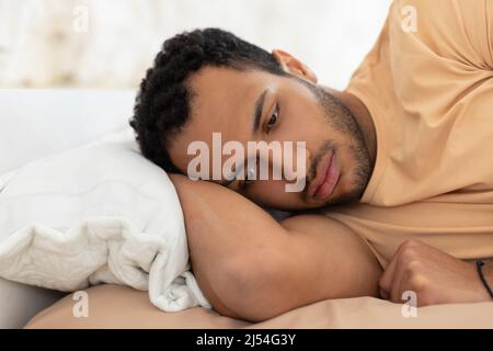 Arabic Guy Having Depression And Insomnia Lying In Bed Indoor Stock Photo