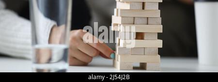 Two players take turns removing wooden blocks from tower Stock Photo