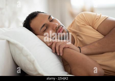 Arabic Guy Sleeping Lying In Bed Napping In Modern Bedroom Stock Photo