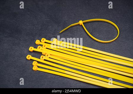 Yellow cable tie on the cement floor background Stock Photo