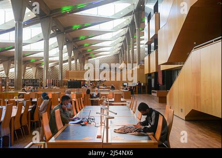 CAIRO, April 20, 2022 (Xinhua) -- People study at the Bibliotheca Alexandrina in Alexandria, Egypt on April 19, 2022. Bibliotheca Alexandrina, a massive unique library and cultural symbol of the Egyptian Mediterranean coastal city of Alexandria which was founded by King Alexander the Great some 2,300 years ago, features a disc-shaped exterior and 11 internal levels, all under one glistening, tilting roof. The iconic library was inaugurated in 2002 as a revival of the original ancient Library of Alexandria, which was one of the largest and most significant libraries worldwide be Stock Photo