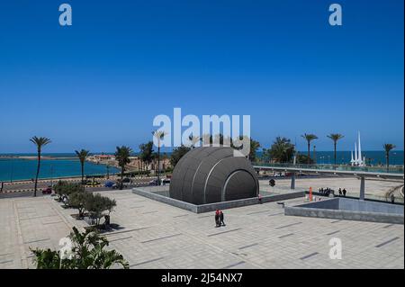 CAIRO, April 20, 2022 (Xinhua) -- People visit the Bibliotheca Alexandrina in Alexandria, Egypt on April 19, 2022. Bibliotheca Alexandrina, a massive unique library and cultural symbol of the Egyptian Mediterranean coastal city of Alexandria which was founded by King Alexander the Great some 2,300 years ago, features a disc-shaped exterior and 11 internal levels, all under one glistening, tilting roof. The iconic library was inaugurated in 2002 as a revival of the original ancient Library of Alexandria, which was one of the largest and most significant libraries worldwide before Stock Photo