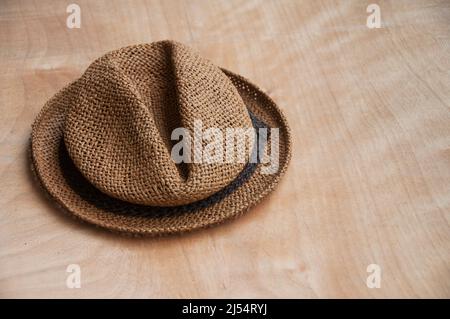 Travelling brown hat on wooden desk. Copy space Stock Photo