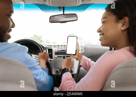 Happy African couple using showing smartphone with empty screen Stock Photo