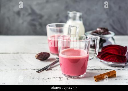 Healthy and tasty beetroot latte with basic ingredients Stock Photo