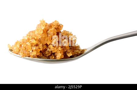 palm sugar candy or rock candy in a spoon, lump sugar made by tapping the sap from the inflorescence of the palm tree, on white background, medicinal Stock Photo
