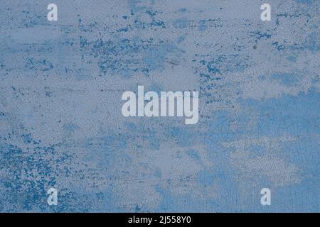Texture of painted surface covered with web of cracks. Surface is painted with three different layers of paint, cracked and partially peeled off. Stock Photo
