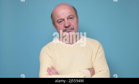 Senior bald sad man looking at camera. Stock Photo