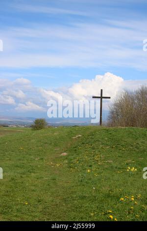 Wooden Easter Cross on green hill at Lane Ends Amenity Area, Pilling, Lancashire. Stock Photo