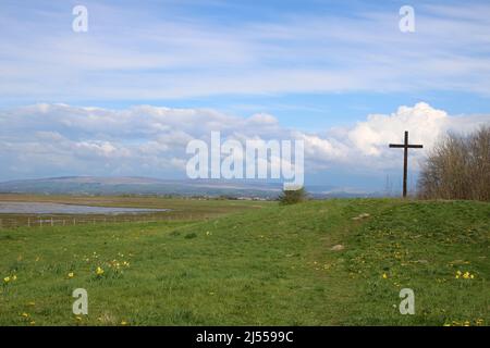 Wooden Easter Cross on green hill at Lane Ends Amenity Area, Pilling, Lancashire. Stock Photo
