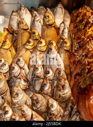 Fish shop: close-up of smoked and dried fish laid out in a shop window Stock Photo