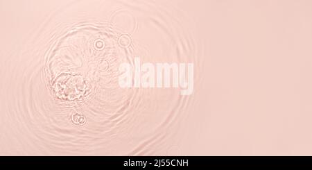 The texture of water on a pink background. Stock Photo