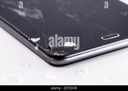 closeup of smartphone model mobile device with broken screen or protective film, white background, copyspace Stock Photo
