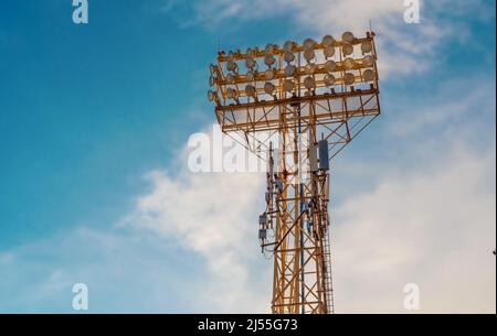 Stadium spotlight set on  background of blue sky. Stock Photo
