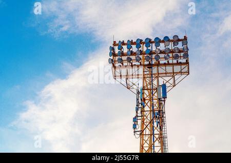 Stadium spotlight set on  background of blue sky. Stock Photo