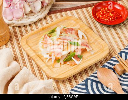 salad pork scalp in a bowl with spoon and chopsticks isolated on mat side view on wooden table taiwan food Stock Photo