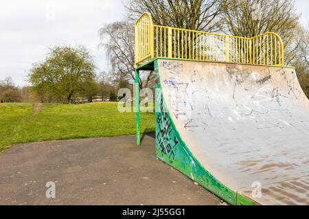 Newcastle-under-Lyme ,Staffordshire-united kingdom April, 11, 2022 Graffiti covered skateboard halfpipe at Lyme valley parkway Stock Photo