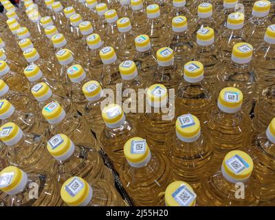 Background with lot of palm or olive oil in bottles. Supermarket sale oil bottles on shelves background, Many cooking vegetable oil bottles sale on th Stock Photo