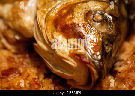 Oven baked carp fish head close up selective focus Stock Photo