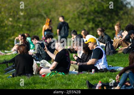 Manchester, UK. 20th Apr, 2022. A group of people sit next to each while smoking joints during the event. Different people take part in unofficial holiday called 420. The 420 holiday is mainly celebrated on April 20th at 4:20pm, on this day many marijuana smokers get together to get high. Credit: SOPA Images Limited/Alamy Live News