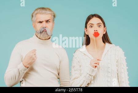 Couple with with fake mustache and lips. Having fun. Photo booth concept. Couple having fun with with fake mustache and lips. Stock Photo