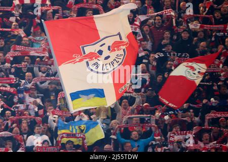 Leipzig, Germany. 20th Apr, 2022. Soccer: DFB Cup, RB Leipzig - 1. FC Union Berlin, semi-final, Red Bull Arena. Leipzig fans wave flags of the club logo and Ukraine. IMPORTANT NOTE: In accordance with the requirements of the DFL Deutsche Fußball Liga and the DFB Deutscher Fußball-Bund, it is prohibited to exploit or have exploited photographs taken in the stadium and/or of the match in the form of sequence pictures and/or video-like photo series. Credit: Jan Woitas/dpa/Alamy Live News Stock Photo