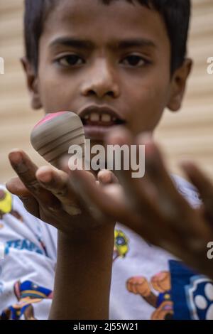 The action of a child in the hands of Latim. This is the traditional art of Bangladesh.Photo was taken March 21, 2022. Stock Photo