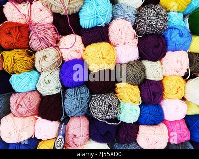 multicolored woolen threads in a ball for knitting close up, the concept of sewing, knitting and needlework Stock Photo