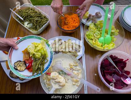 Salad bar with different types of salads and vegetables for a homemade picnic Stock Photo
