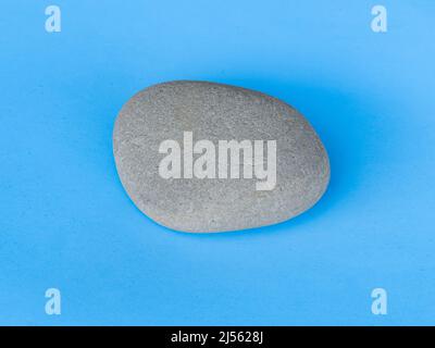gray stone isolated on blue background top view Stock Photo