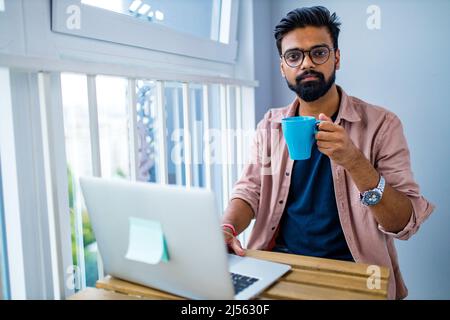 afro mixed race man in casual wear sitting at chill zone Stock Photo