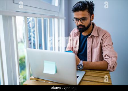 afro mixed race man in casual wear sitting at chill zone Stock Photo