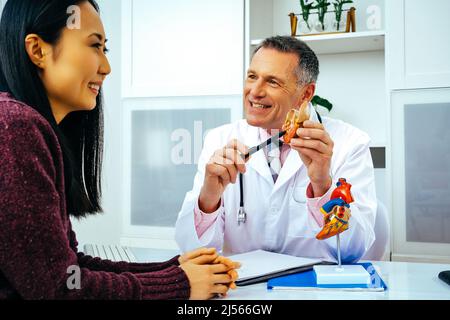 doctor practitioner and patient discussing heart anatomy in the hospital healthcare industry Stock Photo