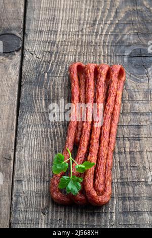 Dry cured  Kabanos sausage on wooden background Stock Photo