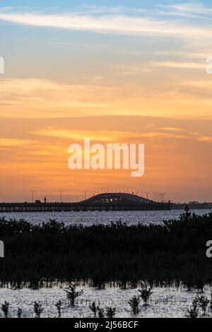 Port Isabel Lighthouse and Queen Isabella Memorial Bridge across the Laguna Madre at sunset.  South Padre Island, Texas. Stock Photo