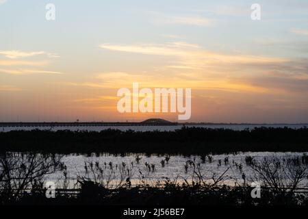 Port Isabel Lighthouse and Queen Isabella Memorial Bridge across the Laguna Madre at sunset.  South Padre Island, Texas. Stock Photo