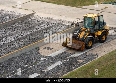 Treated sludge drying in shallow sand drying beds before disposal at a municipal wastewater treatment plant. Stock Photo