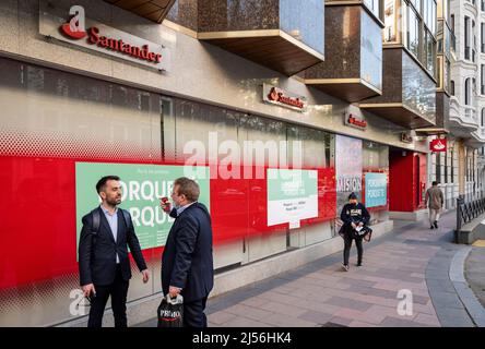 Pedestrians walk past the Spanish multinational commercial bank and financial services of Santander branch seen in Spain. Stock Photo